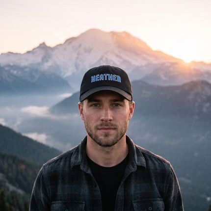 Embroidered black baseball cap featuring blue 'HEATHEN' text.