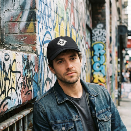 Black baseball cap featuring embroidered "Dead End" warning sign graphic.