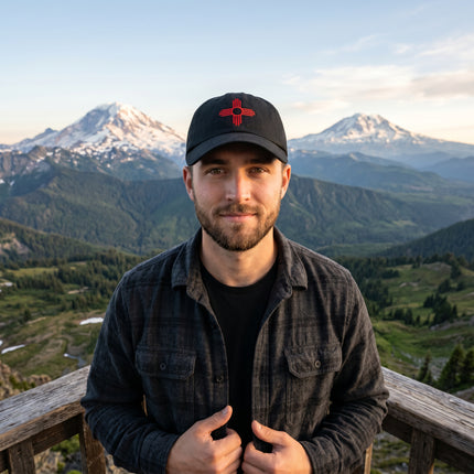 Embroidered black baseball cap featuring the Zia Sun symbol.
