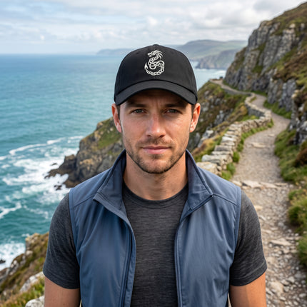 Black baseball cap with embroidered Celtic knotwork dragon design.