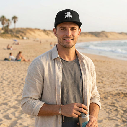 Black snapback cap with white embroidered octopus, perfect for coastal or nautical style.