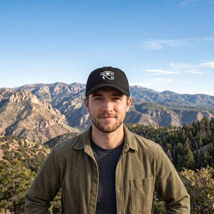 Black baseball cap embroidered with the Eye of Horus Egyptian protection symbol.