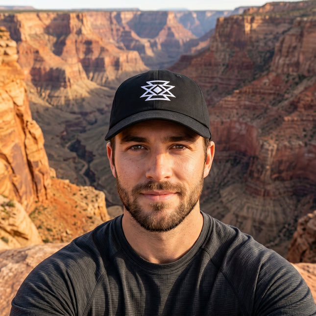 Black baseball cap featuring white embroidered geometric butterfly design.