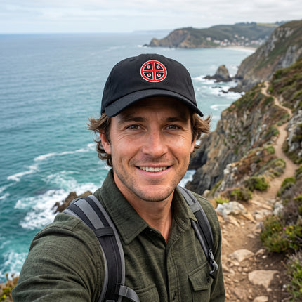 Black embroidered baseball cap featuring the red solar cross symbol design.