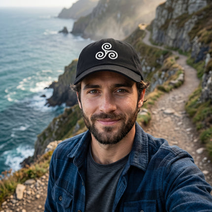 Black embroidered cap with white Celtic triskelion spiral symbol.