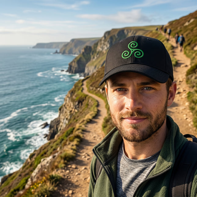 Black baseball cap featuring a green embroidered Celtic Triskelion symbol.