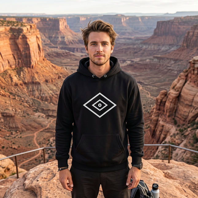 Black pullover hoodie featuring a white geometric Shaman's Eye graphic. Spiritual unisex apparel.