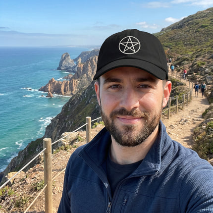Black baseball cap featuring a white embroidered pentagram symbol. Occult or witchcraft style accessory.