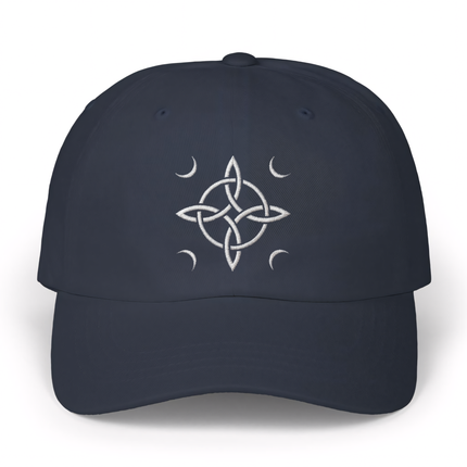 Embroidered witch's knot and crescent moon design on a dark blue dad hat.