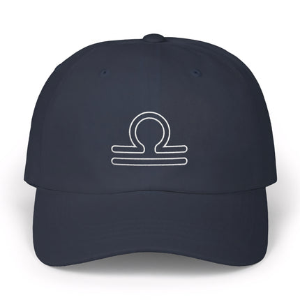 Embroidered Libra zodiac scales symbol on a dark baseball cap.