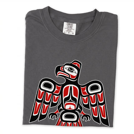 Formline raven design on a black long sleeve t-shirt with red and white accents.
