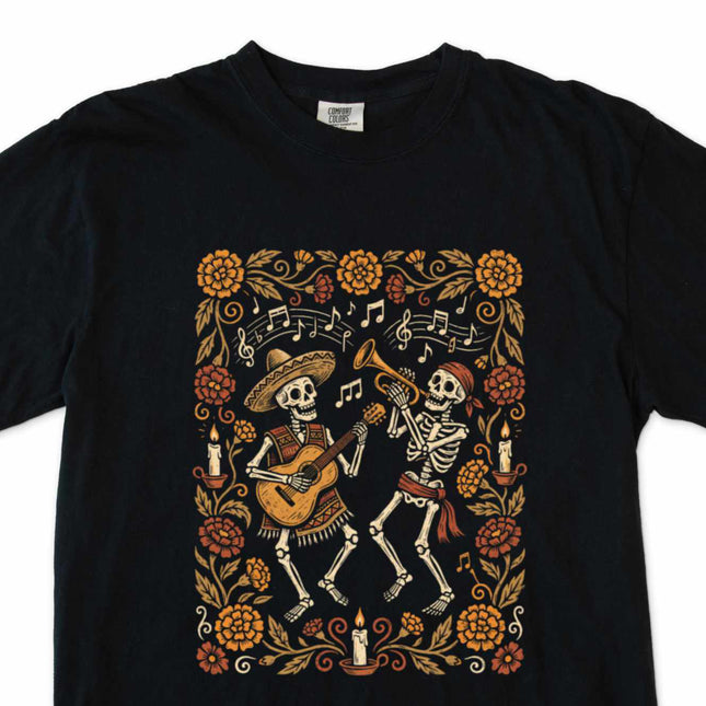 Day of the Dead t-shirt graphic featuring dancing skeletons and vibrant floral motifs.