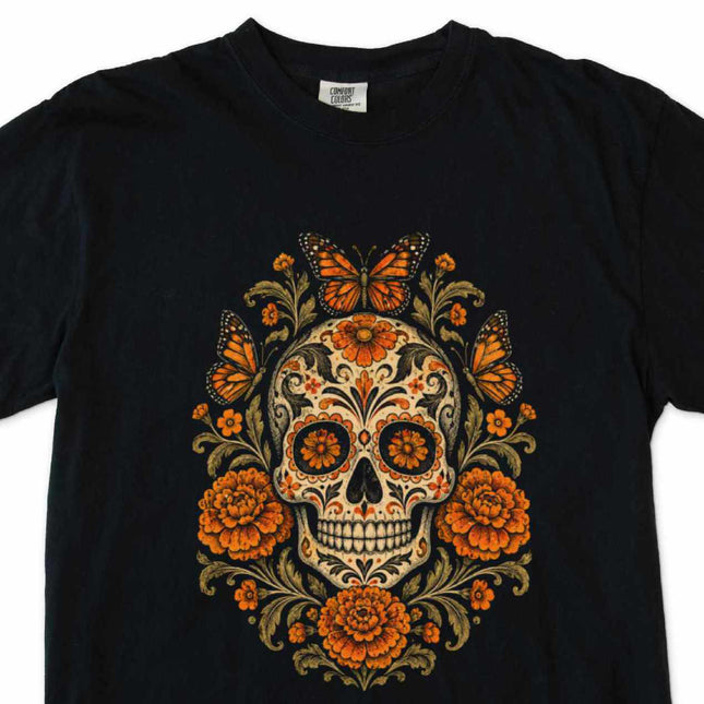 Calavera skull art t-shirt featuring butterflies and vibrant orange floral accents.