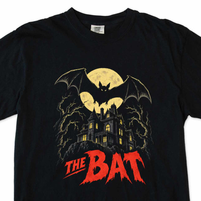 Vintage horror t-shirt featuring a bat and moonlit gothic mansion poster art design.