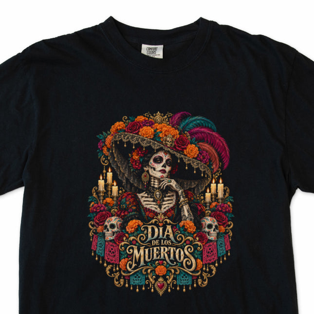 Día de los Muertos t-shirt with floral skeleton portrait and decorative candles.
