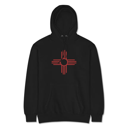 Red Zia sun symbol graphic on a unisex pullover fleece hoodie featuring Native American design.