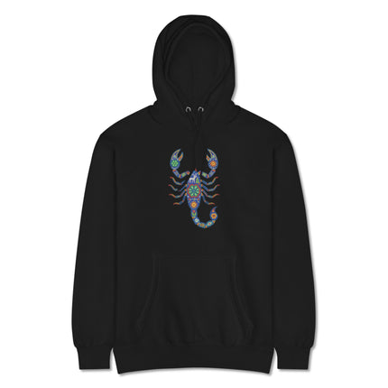 Vibrant Huichol scorpion folk art print on a comfortable pullover hoodie featuring Mexican cultural design.
